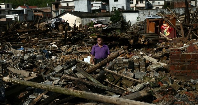 China Daily đưa tin, tại Quảng Tây, 20 nghìn hộ gia đình đã bị cắt điện, đường sá và các cơ sở hạ tầng khác bị hư hại nghiêm trọng. Ảnh: Reuters.