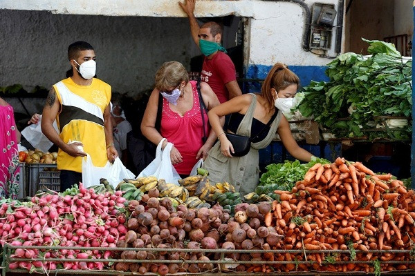 Người dân ở Cuba đeo khẩu trang khi đi chợ. Ảnh: OCN.