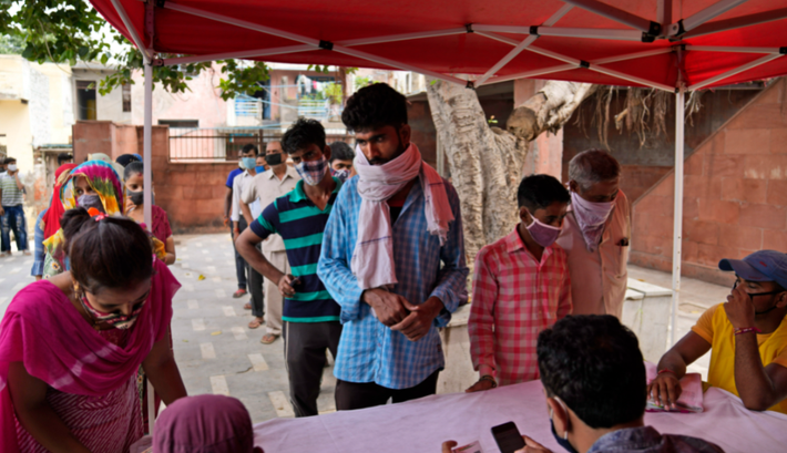 Người dân xếp hàng để đăng ký tiêm vắc xin ngừa COVID-19.