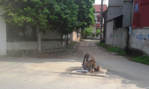 Hòn đá nằm giữa ngã ba của làng Vèo nhưng không ai dám động tới (Ảnh: Đào Tấn). Hòn đá nằm giữa ngã ba của làng Vèo nhưng không ai dám động tới (Ảnh: Đào Tấn).