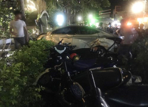 Ôtô tông nhiều xe máy sau khi lao vào quán cà phê. Ảnh: Trần Lộc.