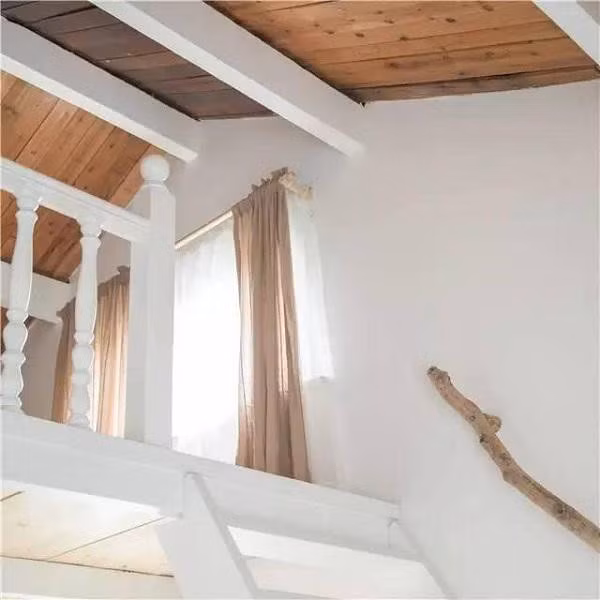 Chiếc cầu thang gỗ trắng muốt dẫn lên phòng ngủ nhỏ.