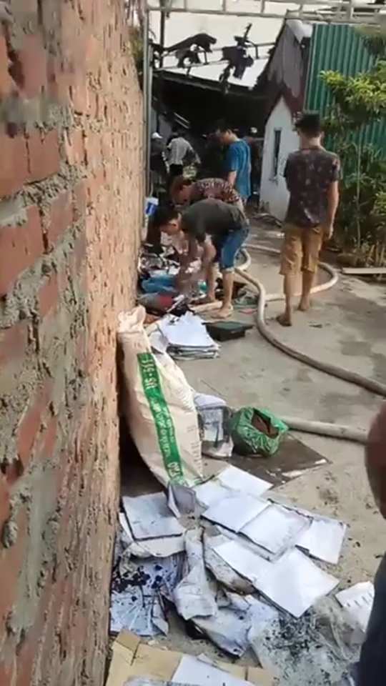 Nhiều vật dụng bên trong nhà xưởng nhanh chóng được đưa ra ngoài. Ảnh CTV.