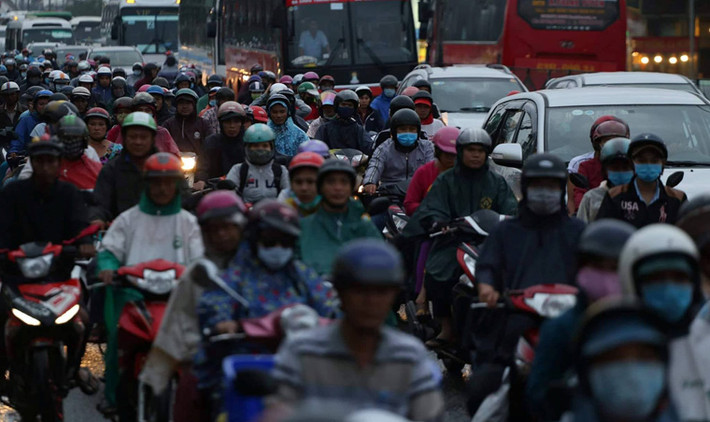 Khu vực đoạn qua cầu Bình Điền (thị trấn Tân Túc, huyện Bình Chánh) lượng người đổ về thành phố ngày càng đông.