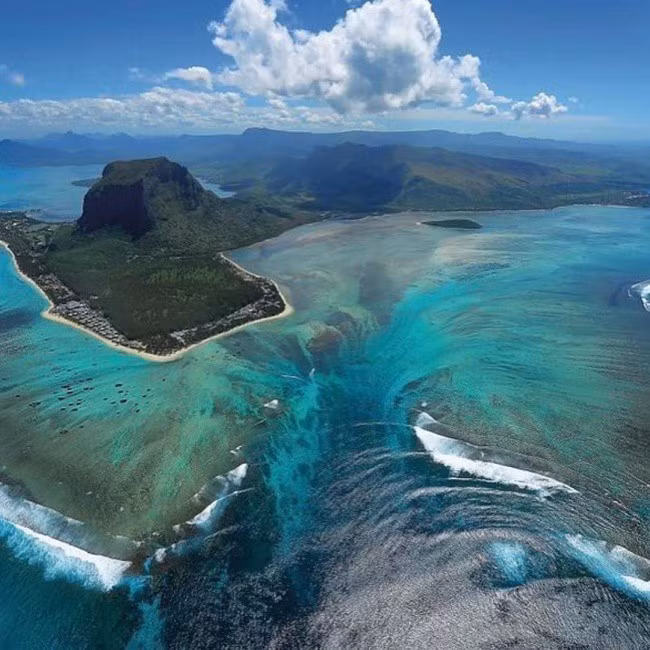 Thác nước ngầm ở Mauritius, đây là một trong nhữnghiện tượng thiên nhiên kỳ lạvà ngoạn mục nhất của Trái đất.Thực chất, không có bất cứ điều bí ẩn nào, chỉ là do vùng biển có quá nhiều màu sắc pha trộn, gây ra ảo giác khi chụp từ trên cao xuống.