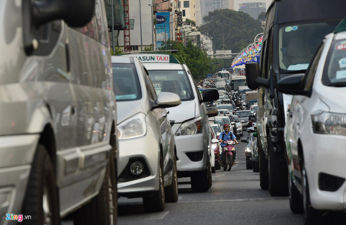 Nhiều người vội vã, sốt ruột đành chạy xe máy len lỏi giữa hai hàng ôtô chật hẹp kéo dài cả cây số.