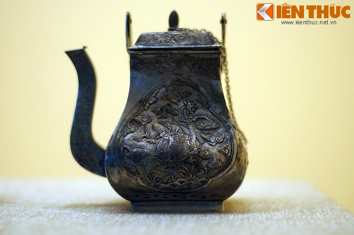 Cận cảnh chiếc ấm. Một mặt ấm khắc hình rùa ngậm cành hoa sen.