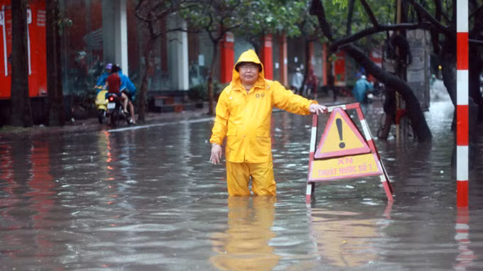 Sau gần 2 giờ mưa tạnh, nước vẫn rút rất chậm tại nhiều tuyến phố. Xe cộ lưu thông vẫn khá vất vả.