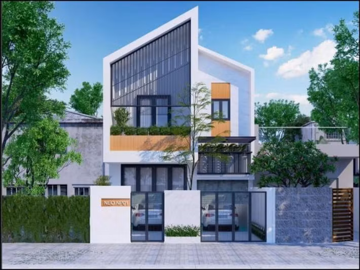 Căn nhà sử dụng sơn tông trắng hiện đại cùng hệ mái chéo độc đáo. Ảnh: Wedo