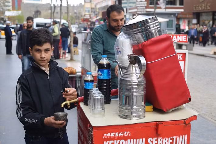 Bé trai ở Diyarbakır này đang bán một loại thuốc thảo dược có hương vị rất nồng nhưng được cho là rất tốt cho sức khỏe.