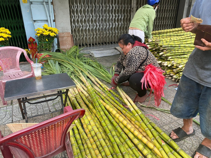 Các tiểu thương tập kết hàng tấn mía “tài lộc” dọc bên đường để phục vụ nhu cầu của người dân mua về làm lễ vật cúng vía Ngọc Hoàng.