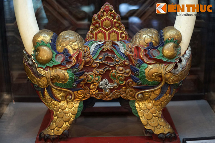 Cặp ngà được cắm vào giá gỗ để sử dụng làm vật trang trí trong cung điện của các vua nhà Nguyễn. Phần giá gỗ được tạo hình lân rất sinh động với phần miệng ngậm lấy ngà. Bốn chân của con lân cũng là chân của giá gỗ. Nước sơn của tác phẩm vẫn còn rất đẹp sau hàng trăm năm tồn tại.