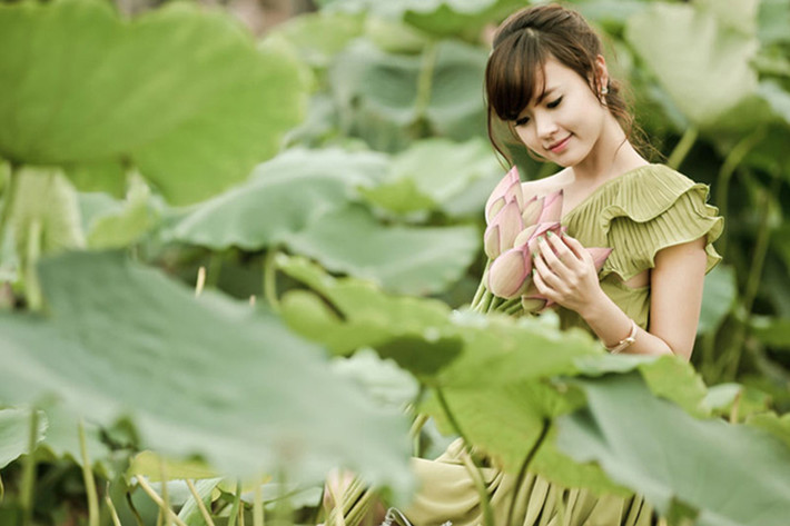 Giữa đầm sen vào mùa hạ, hot girl Midu nổi bật bởi nét đẹp trong sáng và thánh thiện. Ảnh: Dân Việt