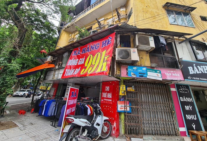 Một cửa hàng vừa treo thông báo xả hàng, vừa treo luôn biển cho thuê nhà.