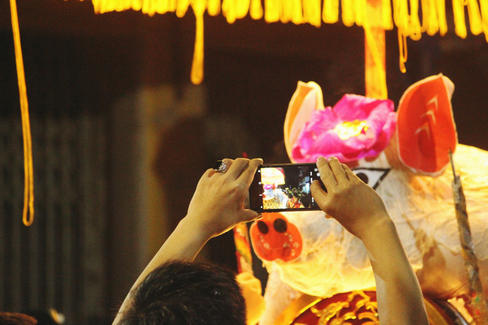 Nhiều người thích thú không quên ghi lại khoảnh khắc "ông lợn" được rước để khoe với bạn bè, người thân.