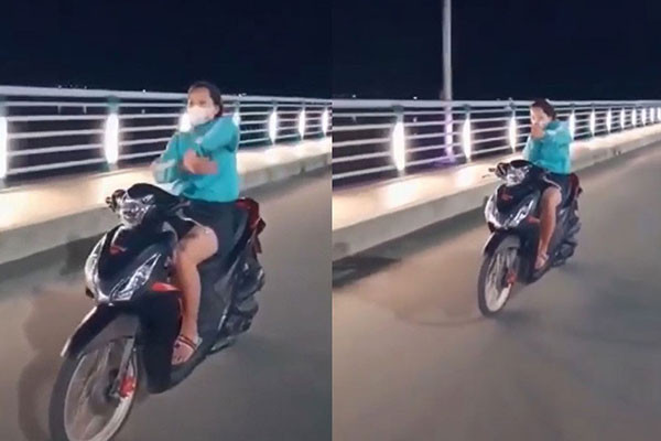 Cô gái đi xe máy thả 2 tay múa quạt ở Quảng Ngãi Co gai di xe may tha 2 tay mua quat o Quang Ngai