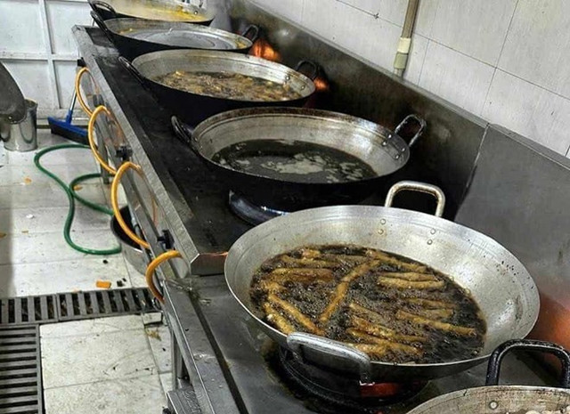 Những chảo dầu đang chiên rán thức ăn có màu đen kịt, khiến phụ huynh lo ngại về sức khỏe của con em mình. Ảnh: Phụ huynh cung cấp bep-an-truong-hoc.jpg
