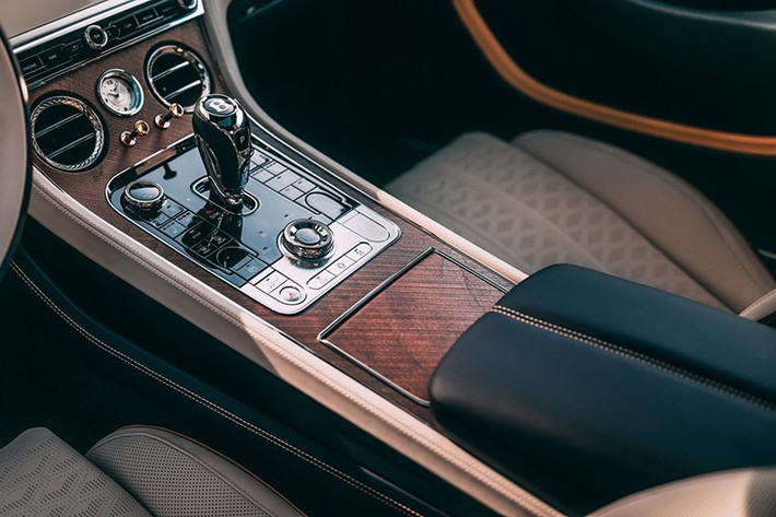 Tấm ốp táp-lô lớn và các dải ốp ngang quanh cabin hoàn thiện Piano kép, chia đôi bằng đường sơn Dark Sapphire đồng bộ ngoại thất. Màu vàng Ấn Độ mà Van Gogh dùng cho các ngôi sao được thể hiện qua da điểm nhấn Khamun, thêu logo Bentley và chỉ khâu tương phản. Các chi tiết đặt biệt khác bao gồm console trung tâm gỗ Walnut chiseled hở lỗ và núm cửa gió mạ vàng.