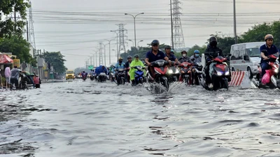 Người dân TP HCM bì bõm trong nước ngập sau mưa trái mùa 